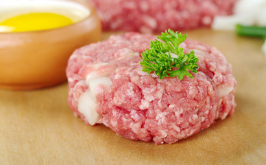 Raw meatball garnished with a parsley leaf