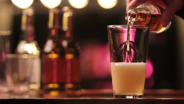 Beer poured into a glass at a bar