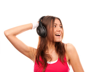 Naklejka premium Girl listening music in headphones and singing