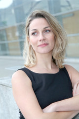 Businesswoman standing outside with arms crossed