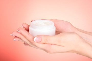 Woman applying cream on her hand