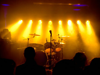 Empty stage at concert, yellow stage lights - obrazy, fototapety, plakaty