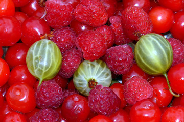 Berry assorted backgrounds. Raspberries, gooseberries, cherries
