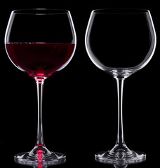 Two Glasses red wine and empty over black background
