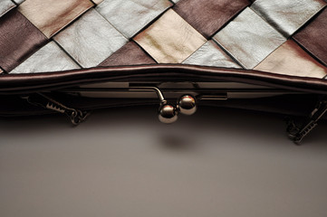 Plaid bag, metal and leather, close-up