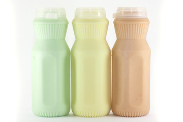 milk (three taste) in a plastic bottle on a white background