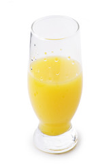 A glass of tangerine juice with water drops isolated on the whit