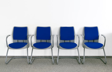 Obraz premium Four Blue chairs in simple empty waiting room
