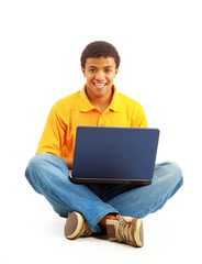 Happy young man working on a laptop, isolated