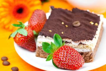 gerbera,  cake and strawberries lying on the orange fabric