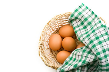 Fresh eggs in a woven basket