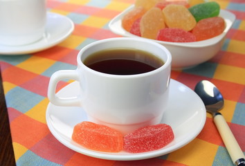 Cup of tea and fruit candy.