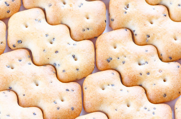 Shaped browned crisp biscuits as tile background