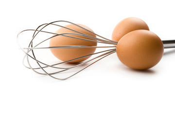 Fototapeta na wymiar Eggbeater and eggs isolated on white