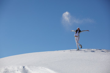 Naklejka na ściany i meble young happy girl plays with a snow