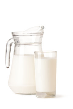 Glass and jar of milk on a white background.