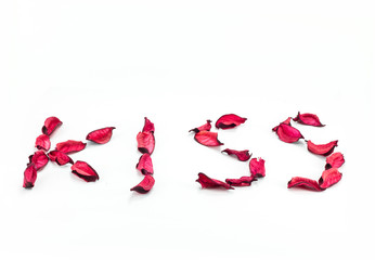 'kiss' written with flower petals