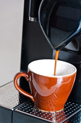 Making a creamy espresso on a black coffee machine