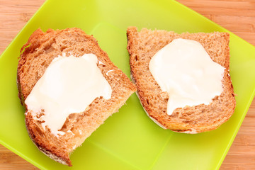 bread with butter in green plate