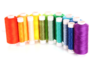Semicircle of many-coloured bobbins of thread isolated on white