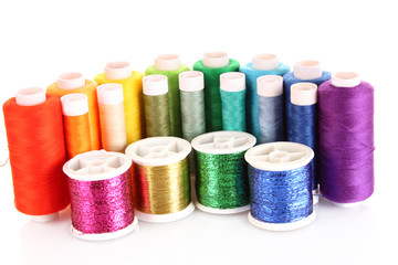 Semicircle of many-coloured bobbins of thread isolated on white