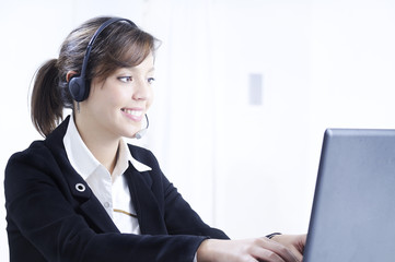 young woman in job; headphones and customer service