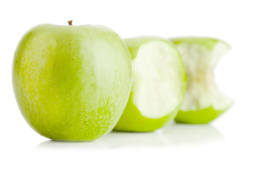 One whole and two bited green apples fruit on white