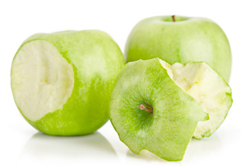 One whole and two bited green apples fruit on white