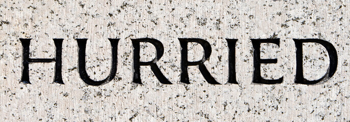 Word "Hurried" Carved in Gray Granite