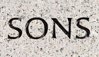 Word "Sons" Carved in Gray Granite