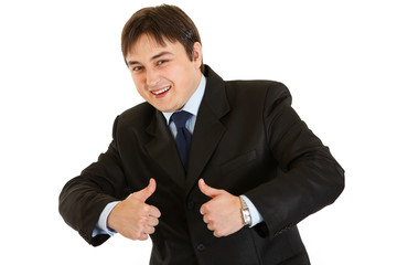 Smiling young businessman showing  thumbs up gesture