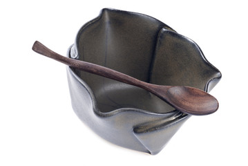 Ceramic Bowl and Wooden Spoon Isolated on White