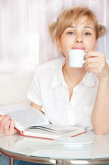 young woman reads  book.