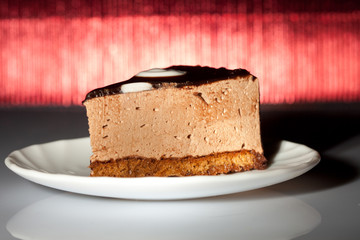 tasty chocolate cake on redbackground