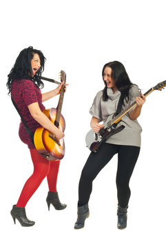 Two women singing with guitars