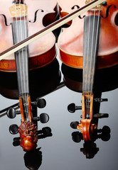 Two violins on dark background