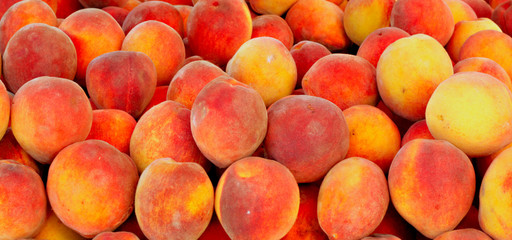 Fresh peaches on market stall