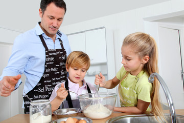 Father and children preparing pancakes