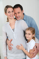 Portrait of family expecting new baby to come