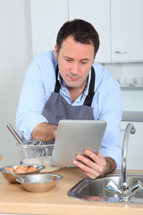 Man looking at recipe on internet