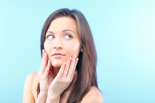 Beautiful Happy Woman Is Looking Sideways And Touching Her Face