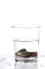 Glass of water with coins