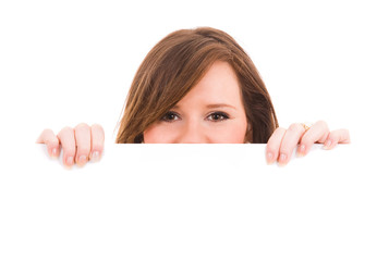 Picture of beautiful brunet woman holding a blank billboard
