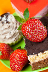 cake and strawberries lying on the orange fabric