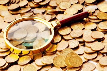 Magnifying glass and coins at the background