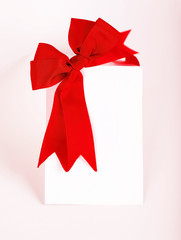 Beautiful red bow over blank card