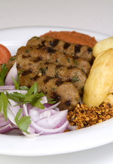 a plate with greek grilled meat