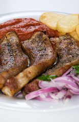 a plate with greek grilled meat
