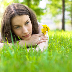 young beautiful teenager with dandelion bouquet