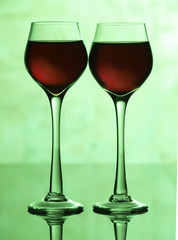 Two wine glasses on green